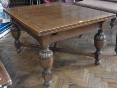 Stained oak extending dining table, on turned baluster supports united by cross stretchers, 130cm