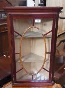 A reproduction mahogany corner cupboard, the astragal glazed door enclosing three shelves, height