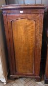 A Victorian mahogany single cupboard, with arched panel door, enclosing hanging space, on bracket