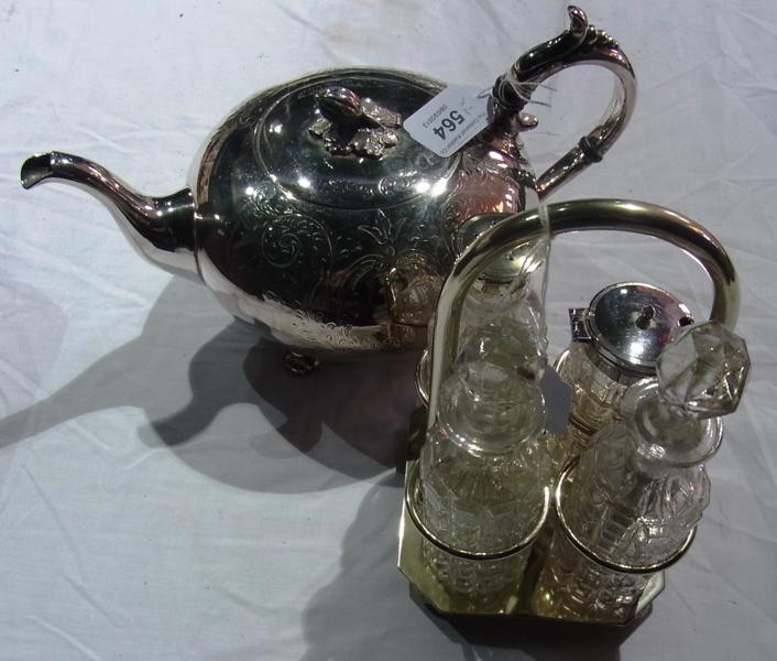 A silverplate teapot of compressed bullet form, with pomegranate finial, scroll handle and