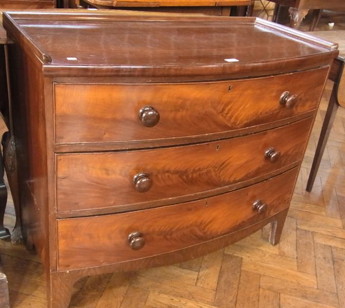 Nineteenth century bow-front chest of drawers, with moulded gallery top, the three long graduated