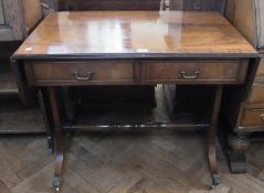 A reproduction mahogany sofa table with two frieze drawers, opposed by dummies, on twin pedestal