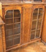 Mid twentieth century walnut veneer display cabinet, the twin astragal glazed doors enclosing
