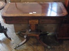 A Regency inlaid mahogany foldover card table, raised on a marquetry inlaid vase-shaped pedestal and