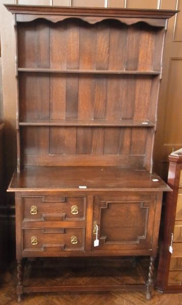 20th century Jacobean style oak dresser with open two shelf platerack, two moulded front short