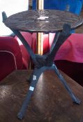 Small carved African circular tripod table, decorated with animals, 33cm wide