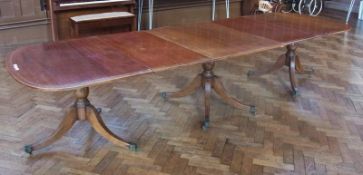 George III style mahogany triple pedestal dining table, with extra leaves