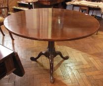 A 19th century mahogany tilt-top tea table, on turned column and three downswept cabriole supports