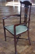 1930s mahogany Art Nouveau style highback elbow chair, with green padded upholstered seat, on X-