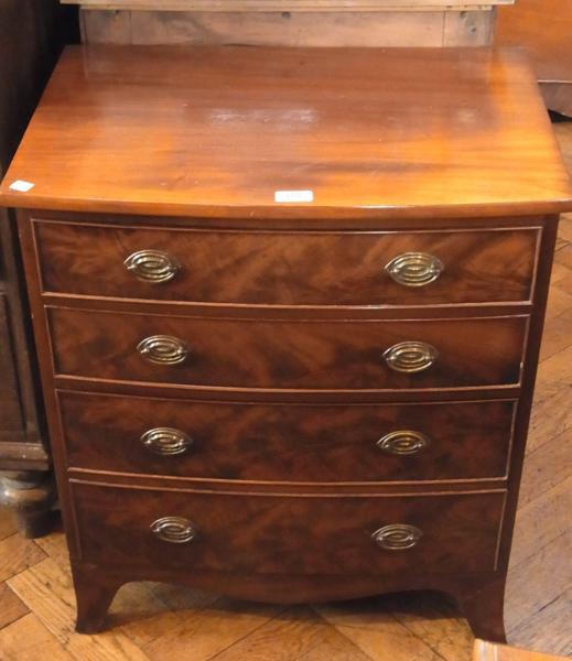 A reproduction mahogany bowfront chest of four long graduated drawers on splayed bracket feet, width