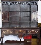 A George III style oak dresser, with boarded back, pierced frieze and on cabriole supports