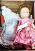 A Rosebud doll wearing gingham dress with various other doll's clothes, shoes, boots, etc (1 box)