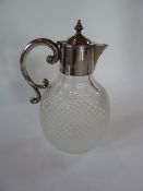 A cut glass claret jug with silverplated mounted collar and handle