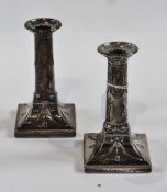 Pair Edwardian silver candlesticks, with neoclassical swags and drape decoration, raised on square