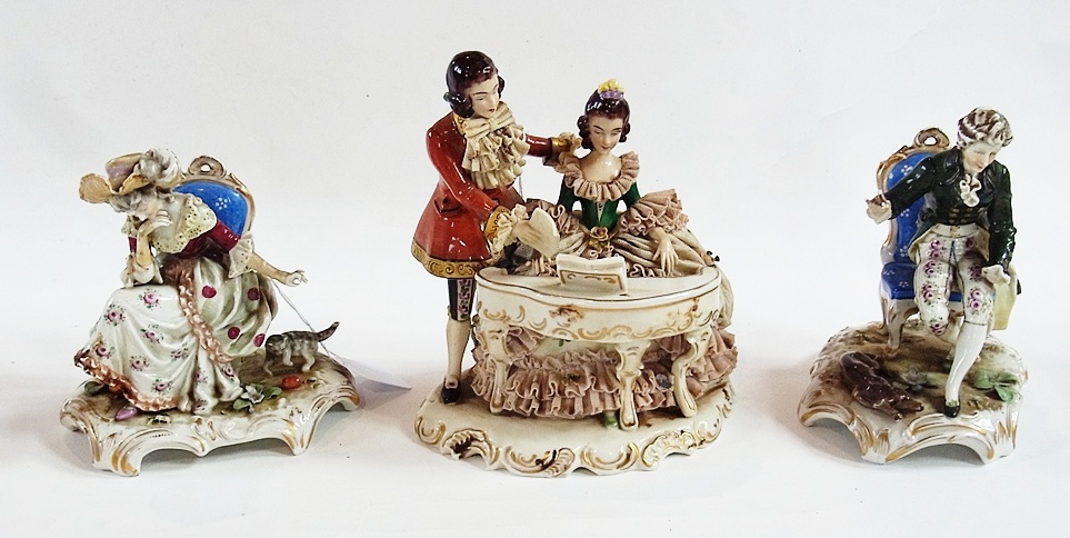 Pair of Dresden figures seated and playing with pet animals, together with a Capodimonte figure