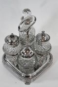 Victorian silver cruet stand, with four cut glass bottles, silvercapped (one collar plates),