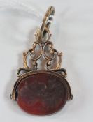 Georgian gold-coloured metal and intaglio carved cornelian revolving seal, the oval seal carved with