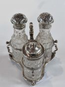 Victorian silver capped three cut glass bottle cruet set, within a silver stand, with carrying