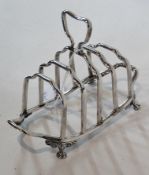 A Victorian silver four-division toastrack, with carrying handle, raised on paw feet, Birmingham
