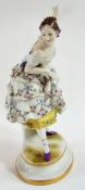 German porcelain Continental figure of a dancing girl with overall floral decoration to her dress,