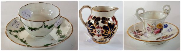 A 19th century two handled English china cup, of ogee form, having ring and scroll handles,