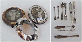 Two silver photograph frames, pickle forks, butter knives, cocktail swizzle stick etc