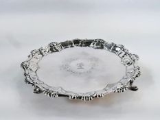 George III silver card tray, circular with raised anthemion and scroll border, crest engraved to