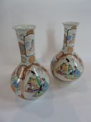 Pair Chinese porcelain bottle vases, each decorated with figures in shaped reserves, floral