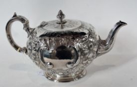 A Victorian silver teapot,  of bullet form, with repousse, foliate and C-scroll decoration, raised