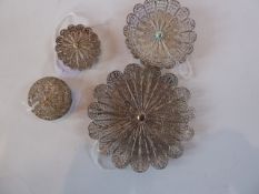 A set of filigree white metal to include two small dishes and two pill boxes (4)
