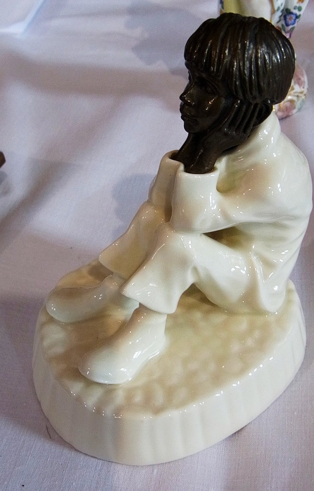 A Minton's porcelain figurine "Spellbound" MS2, seated figure of a boy resting his head on his