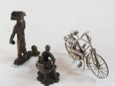 Silver miniature model of a bicycle, stamped 1890, with import marks, and two white metal figures of