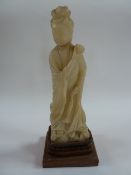 Chinese carved alabaster figure of Kuan-Yin, on carved hardwood base, 34cm high overall and the