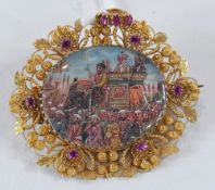 Indian gold and ruby set pictorial miniature brooch, oval and depicting a ceremonial procession with