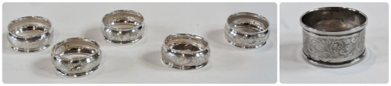 Set of five George V silver napkin rings, with foliate engraving, Chester 1910 together with