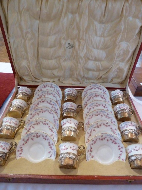 A Royal Doulton comprehensive coffee set, comprising twelve cups and saucers with hand painted