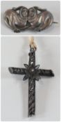 Silver twin animal brooch, each having human face and a silver filigree crucifix, (2)