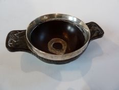 A Scottish Celtic revival quaiche, the carved wooden bowl raised on a white metal foot and a white