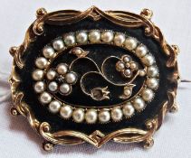Mid Victorian gold, black enamel  and  seedpearl mourning brooch, oval with scroll border, floral