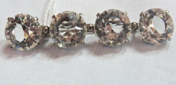 White metal and white sapphire (?) brooch, set four cut stones