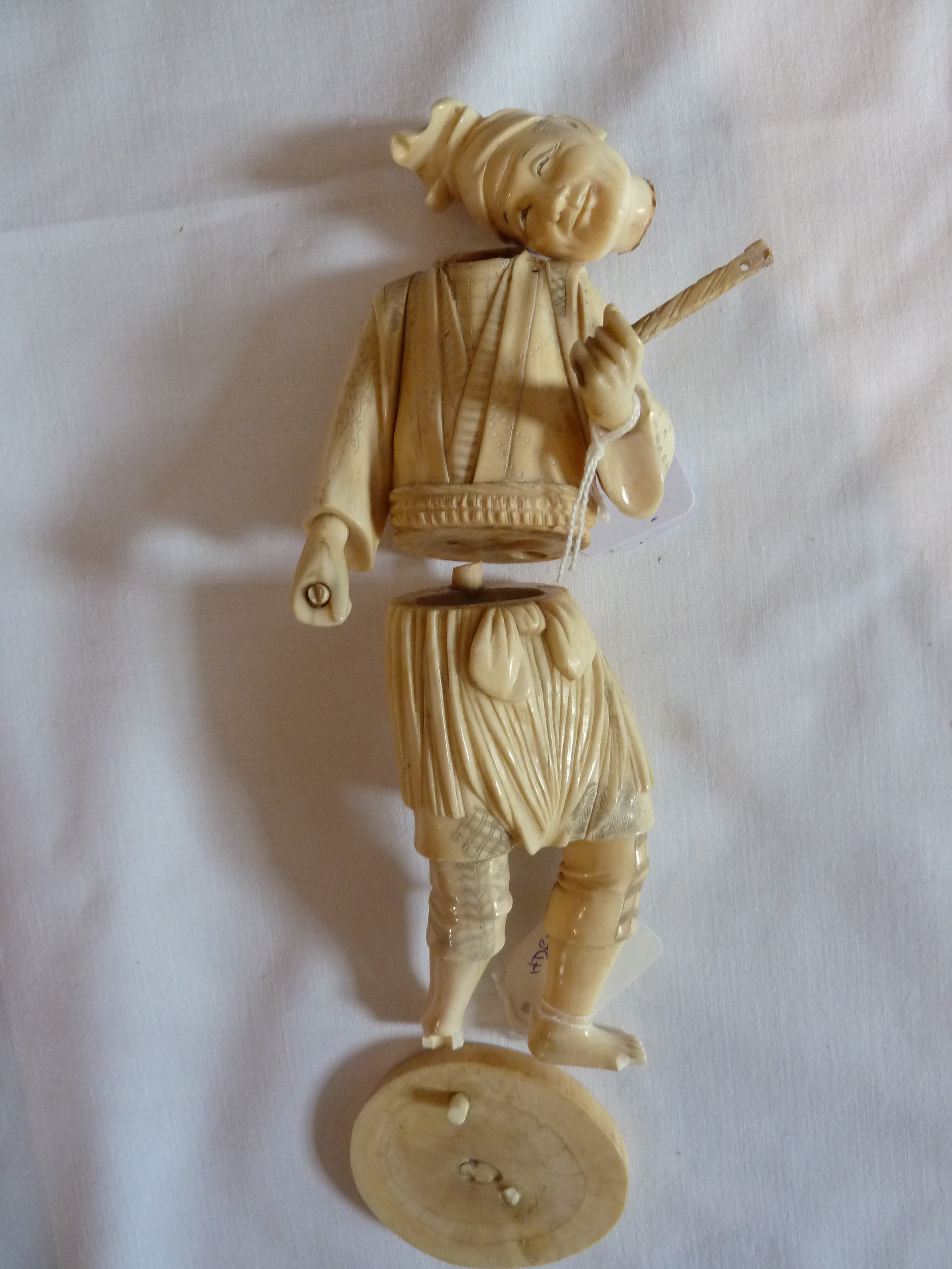 Japanese carved ivory figure of a standing man (af), 23cm high approximately