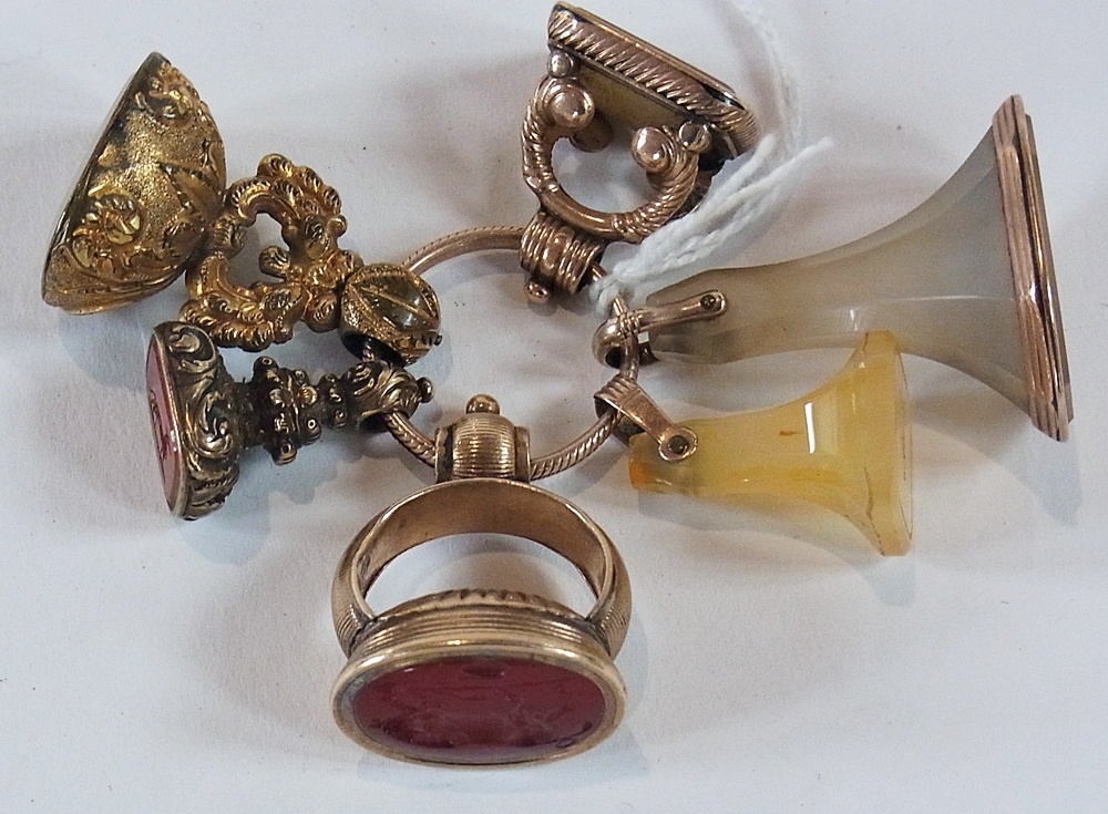 Six various Georgian and later gold-coloured metal seals, set intaglio carved cornelian and other