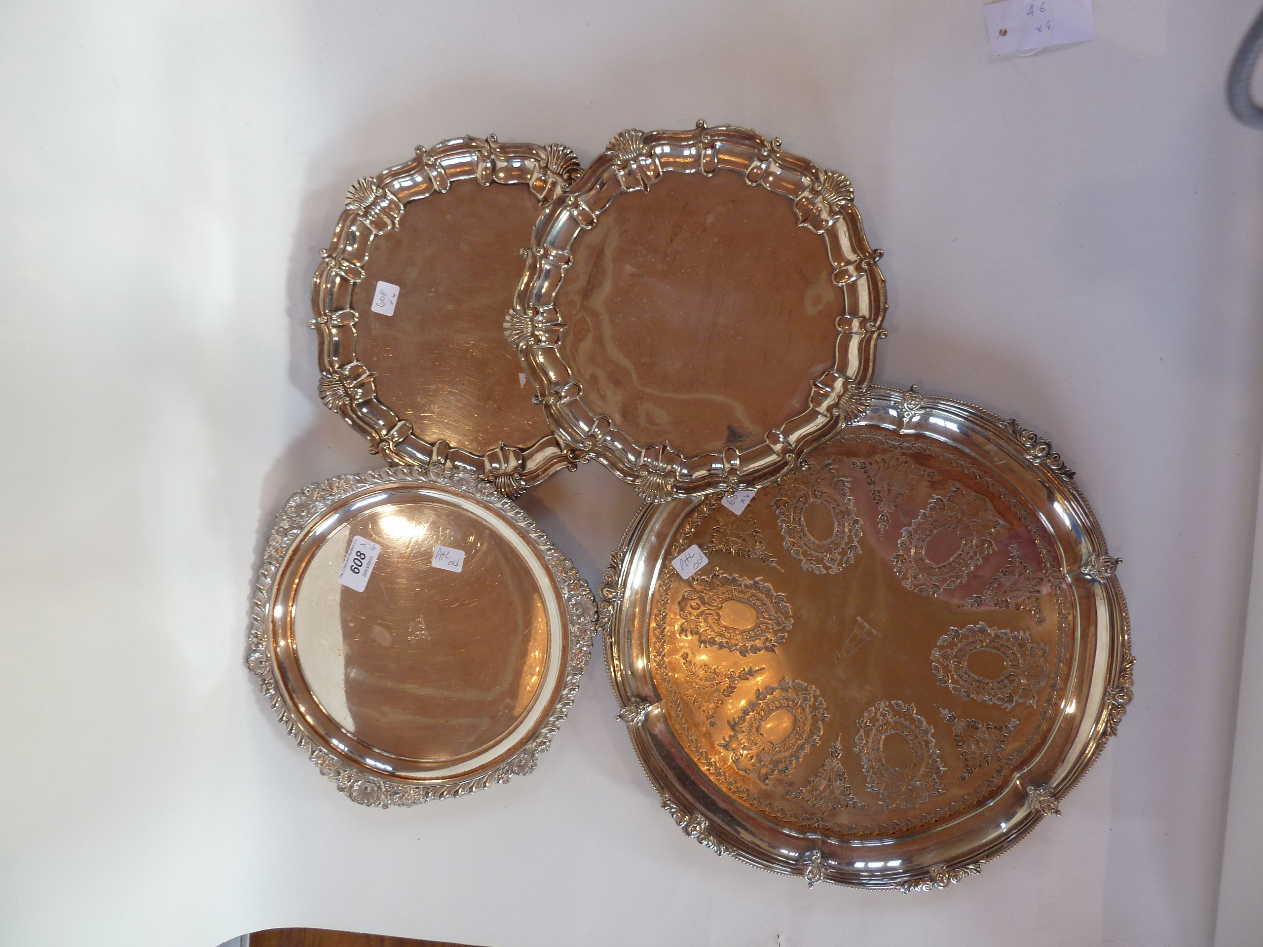 A pair of silverplated trays, large silverplated salver with engraved decoration and a small