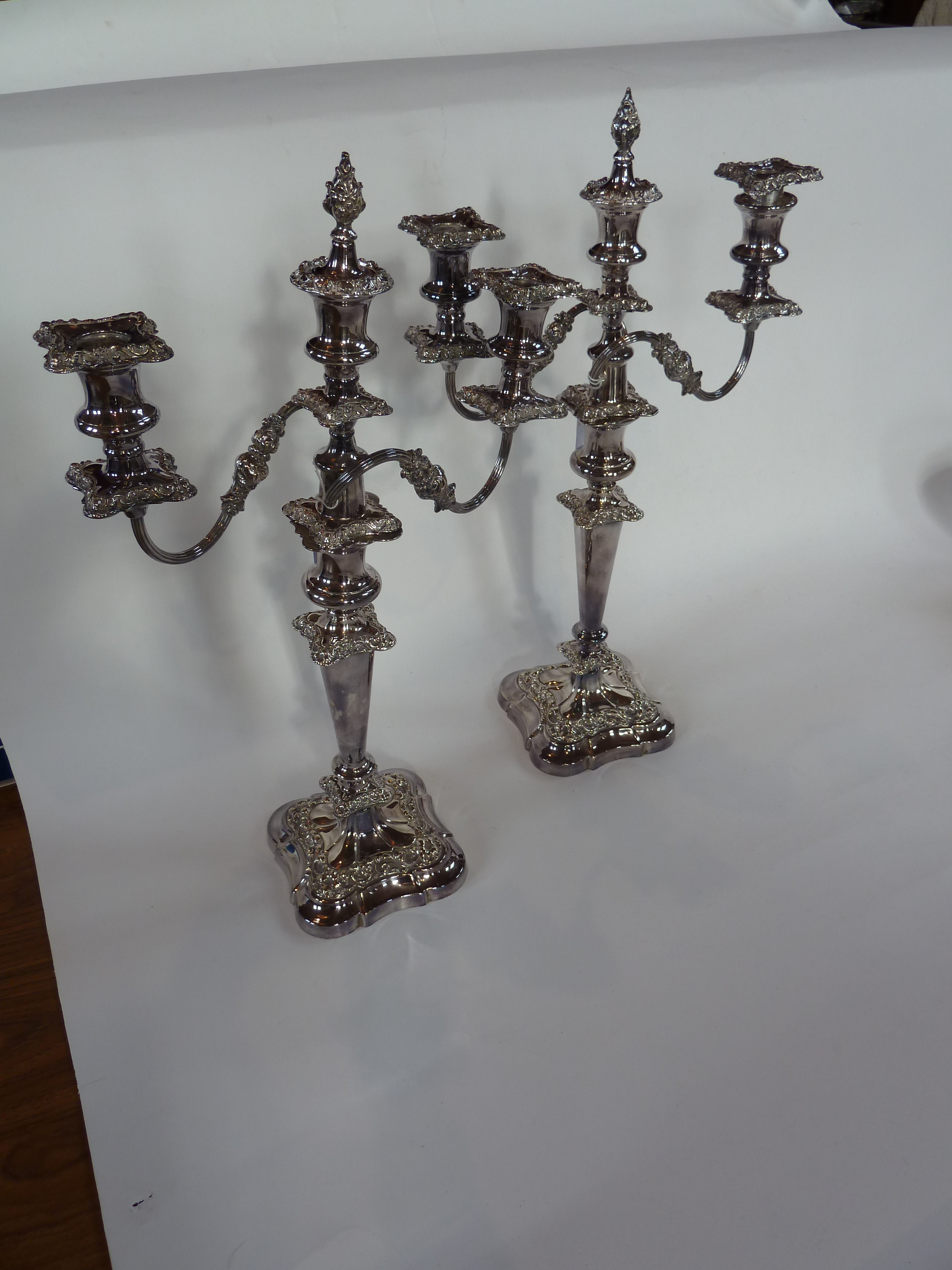 A pair of two branch candelabra with central candleholder with finial, removable sconce, drip