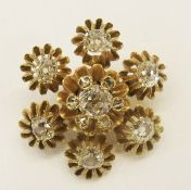 Gold and diamond flowerhead brooch, set centre diamond, having surround of six diamond chips, within