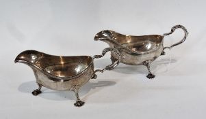 A pair Elizabeth II silver gravy boats, with reeded border, foliate scroll handles, on cabriole legs