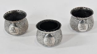 Set of three Victorian silver open salts, with foliate scrollwork repousse decoration, Sheffield