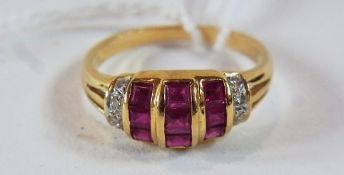 Gold coloured metal ruby and diamond dress ring, set three rows square cut rubies flanked by