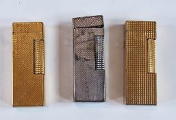 Two Dunhill gold plated cigarette lighters and a silver plated Dunhill lighter (3)