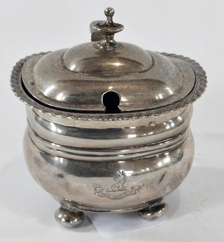 George V silver mustard pot and cover, of oval form, with gadrooned borders, hinged cover with